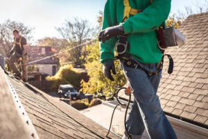 roofer inspecting roof for roofing insurance claims